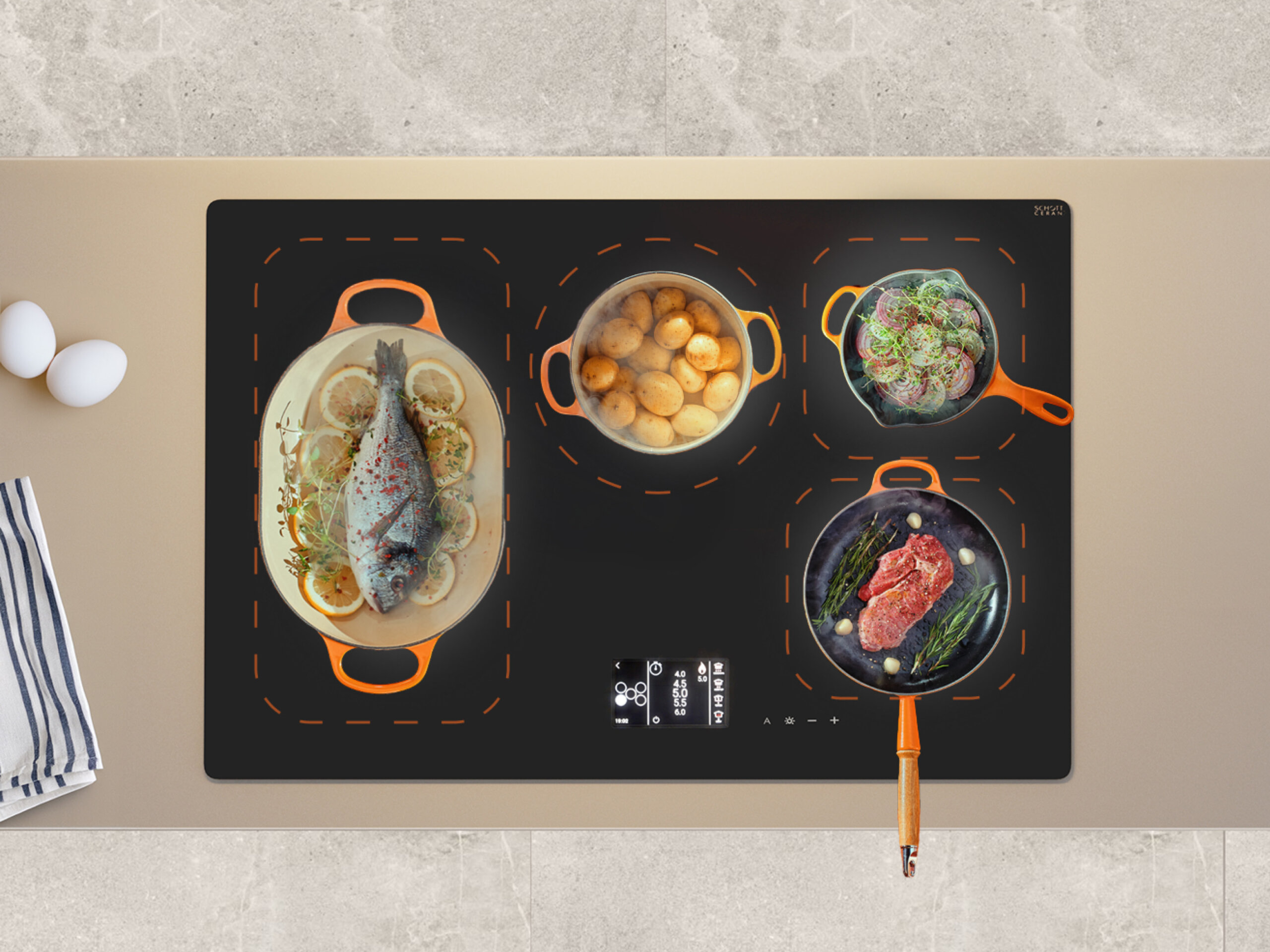 Płyta indukcyjna z czterema naczyniami na blacie.